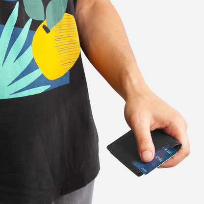 Hand taking out a card from one of the card slots on the Slim Cork Wallet. Black Cork.