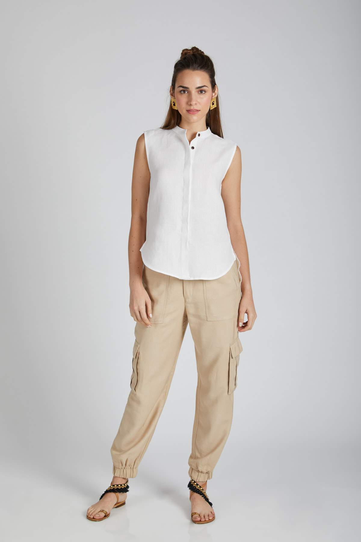 White Zephyr Sleeveless Shirt for Women by B Label. Refresh your wardrobe with this casual, high-low top. Made of 100% hemp, it is breathable and comfortable. Pair it with shorts and sneakers or trousers and heels for a stylish look.