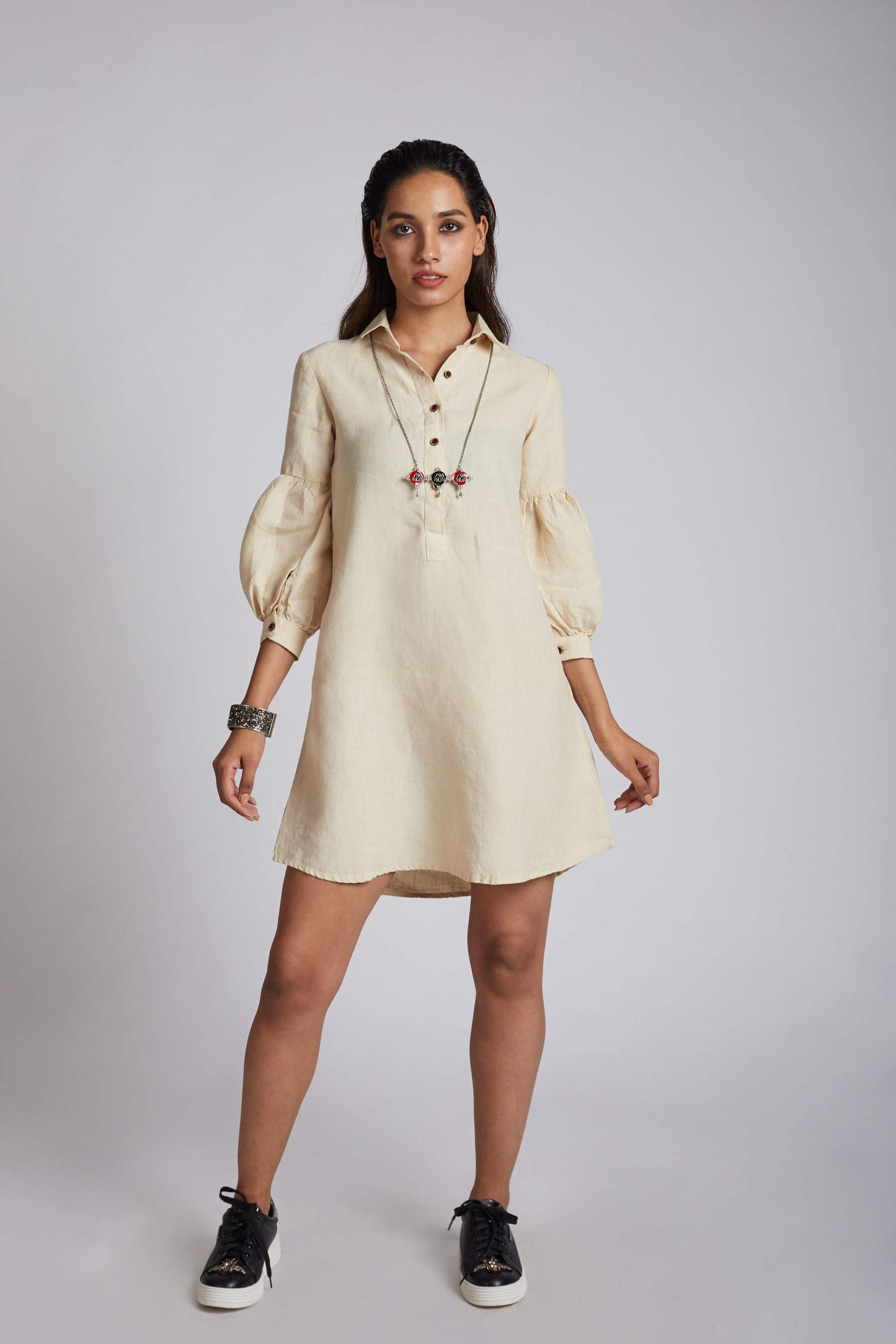 Beige Horizon Lego Mutton Shirt Dress for Women is made with 100% hemp for a breathable and comfortable wearing experience. This sustainable clothing piece features an elegant twist on the famous lego-mutton sleeves, with a collar and buttons for added style. Stand out from the crowd with this unique and fashionable dress.