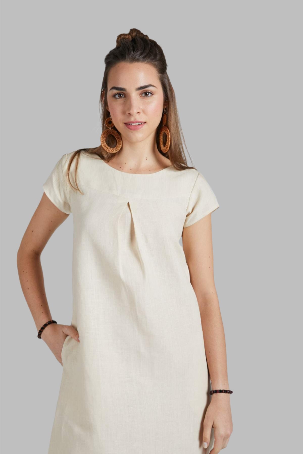 Beige Willow A Line Dress by B Label is made with 100% hemp, offering breathability and comfort. With cap sleeves and an A-line flare detail, this dress provides the perfect fit and allows freedom of movement. Pair it with your favorite accessories for a stylish and effortless look.