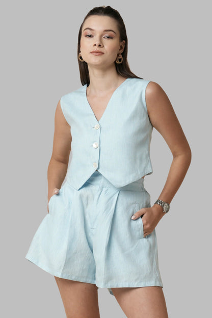 Light Blue Serene Top for Women by BLabel is a sophisticated and elegant piece of sustainable clothing. Made with 100% hemp, it is breathable and comfortable. The waistcoat-inspired design features a flattering tailored silhouette and three naturally polished buttons, adding a touch of refinement to any ensemble.