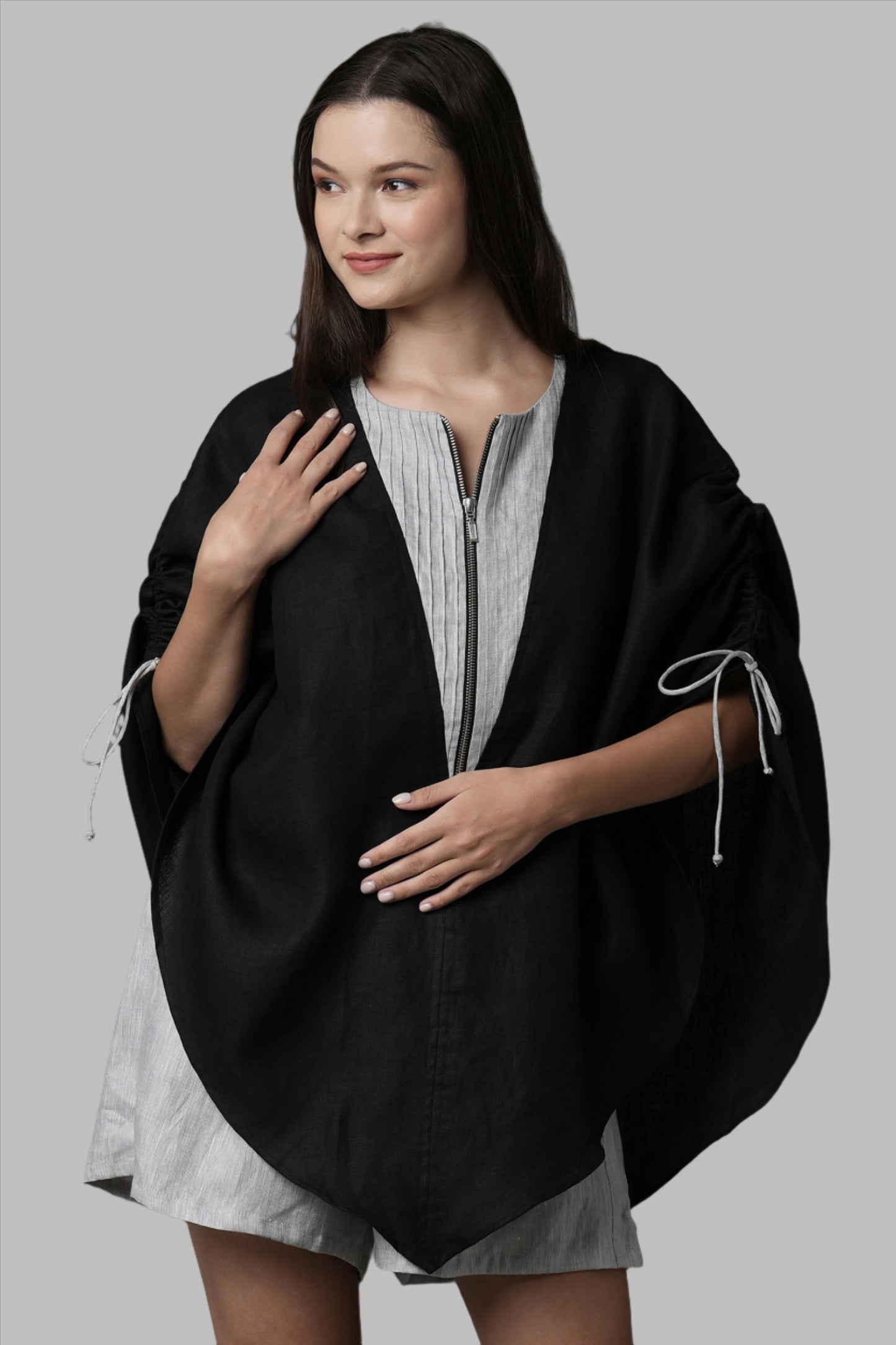 Unleash your spirit with this zipper top designed for every kind of body. A breezy poncho, this overlay can be slipped over a swimsuit, a tank top or be worn as is. Its pin tuck and adjustable drawstring details at the shoulder finish the top with the perfect elements.