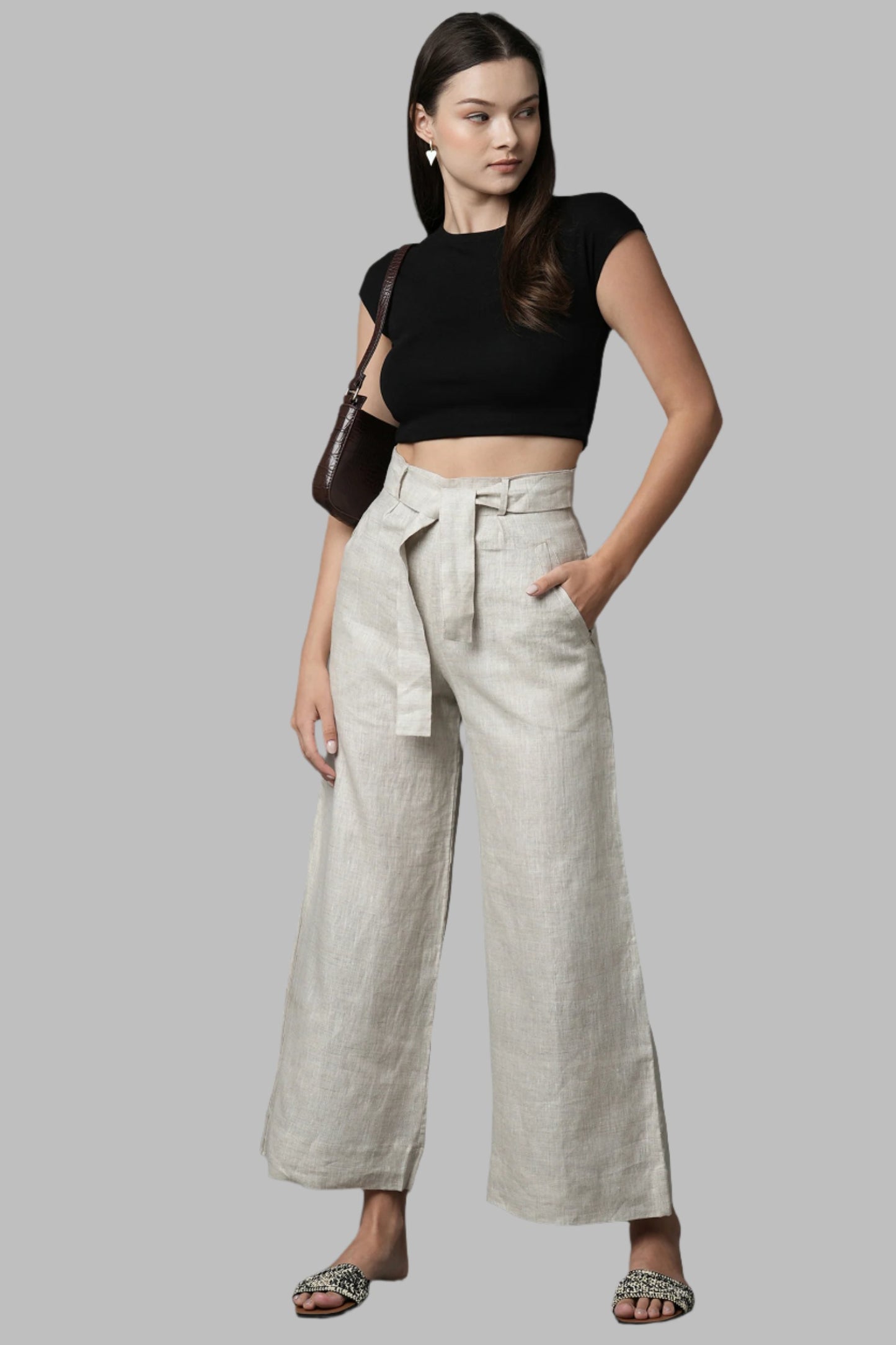 Oatmeal Tranquil Pants for Women by B Label are crafted from 100% pure hemp, offering both style and sustainability. These high waist culotte pants feature flowy and flared design with stitching and pin tuck details. Customize your look with the cloth belt that can be tied in the front or back. Embrace a conscious wardrobe with these comfortable and eco-friendly pants.