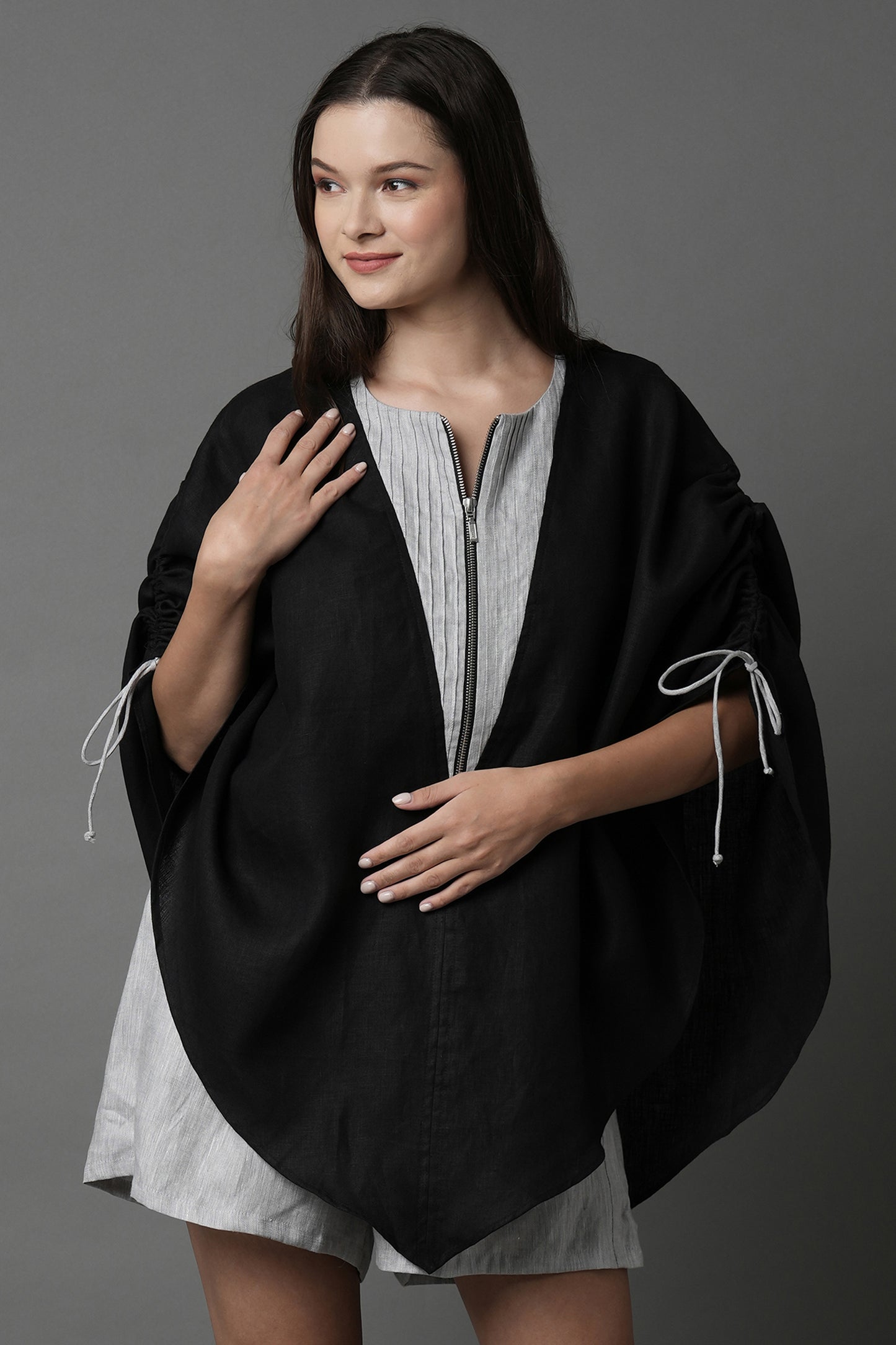 Unleash your spirit with this zipper top
designed for every kind of body. A 
breezy poncho, this overlay can be
slipped over a swimsuit, a tank top
or be worn as is. Its pin tuck and 
adjustable drawstring details at the 
shoulder finish the top with the
perfect elements.